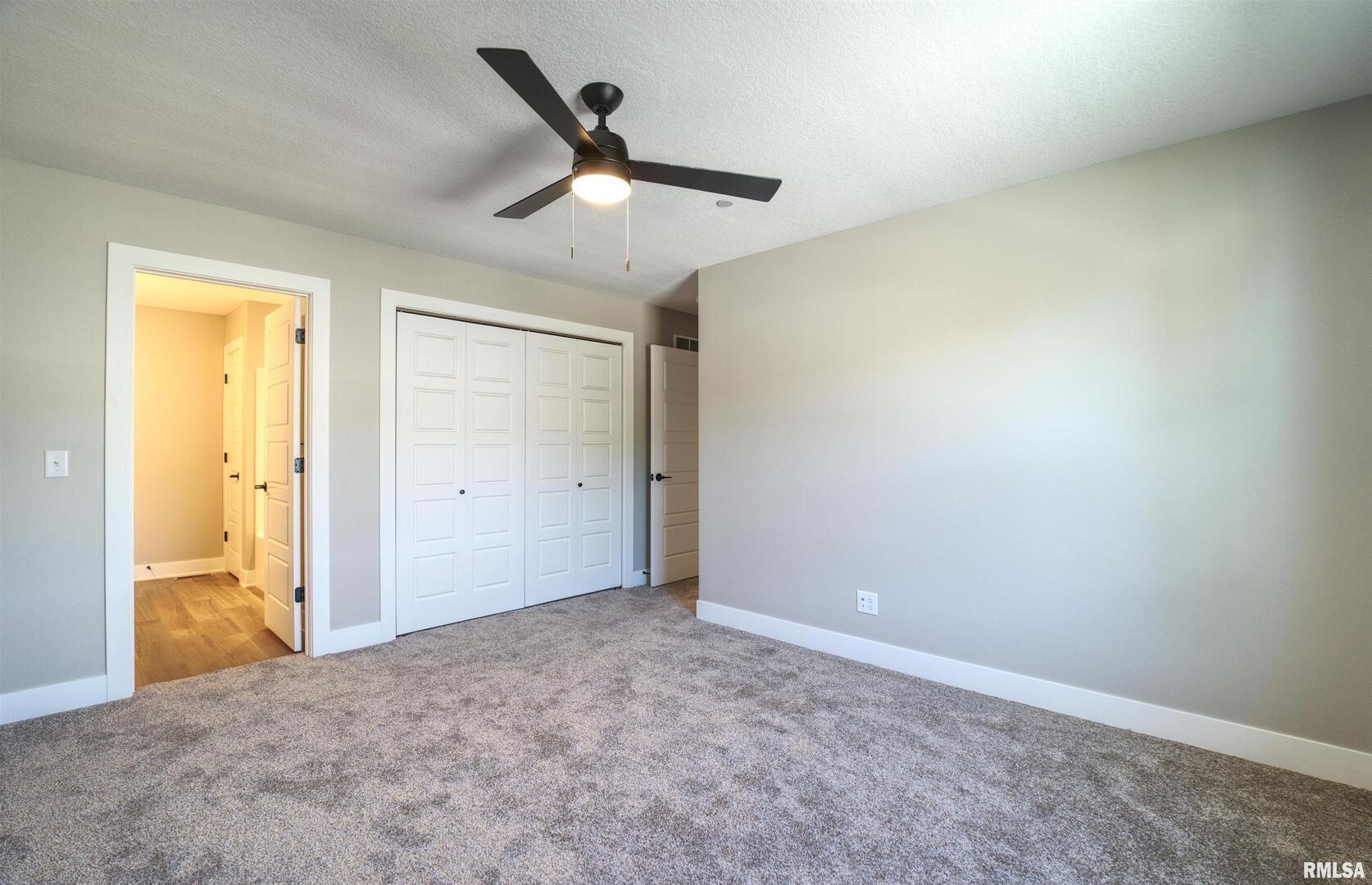 1002 South 4th Street Clinton, IA 52732 - Photo 8 of 19 an empty room with closet and windows