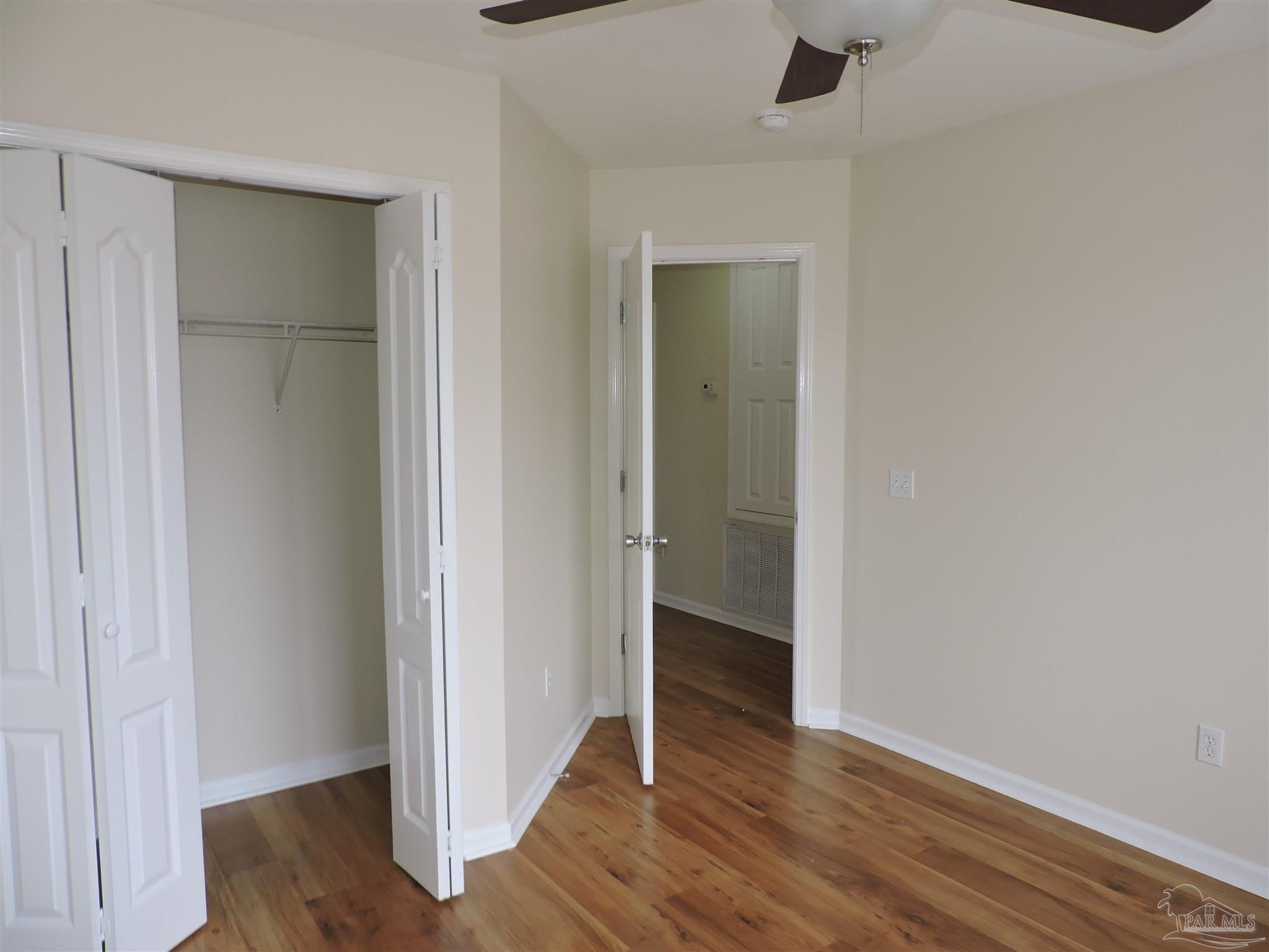 7070 Marissa Point Lane Milton, FL 32570 - Photo 14 of 21 a view of an empty room with wooden floor