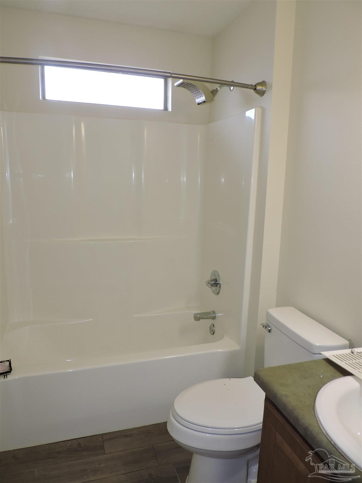 7070 Marissa Point Lane Milton, FL 32570 - Photo 17 of 21 a bathroom with a granite countertop toilet a sink and bathtub