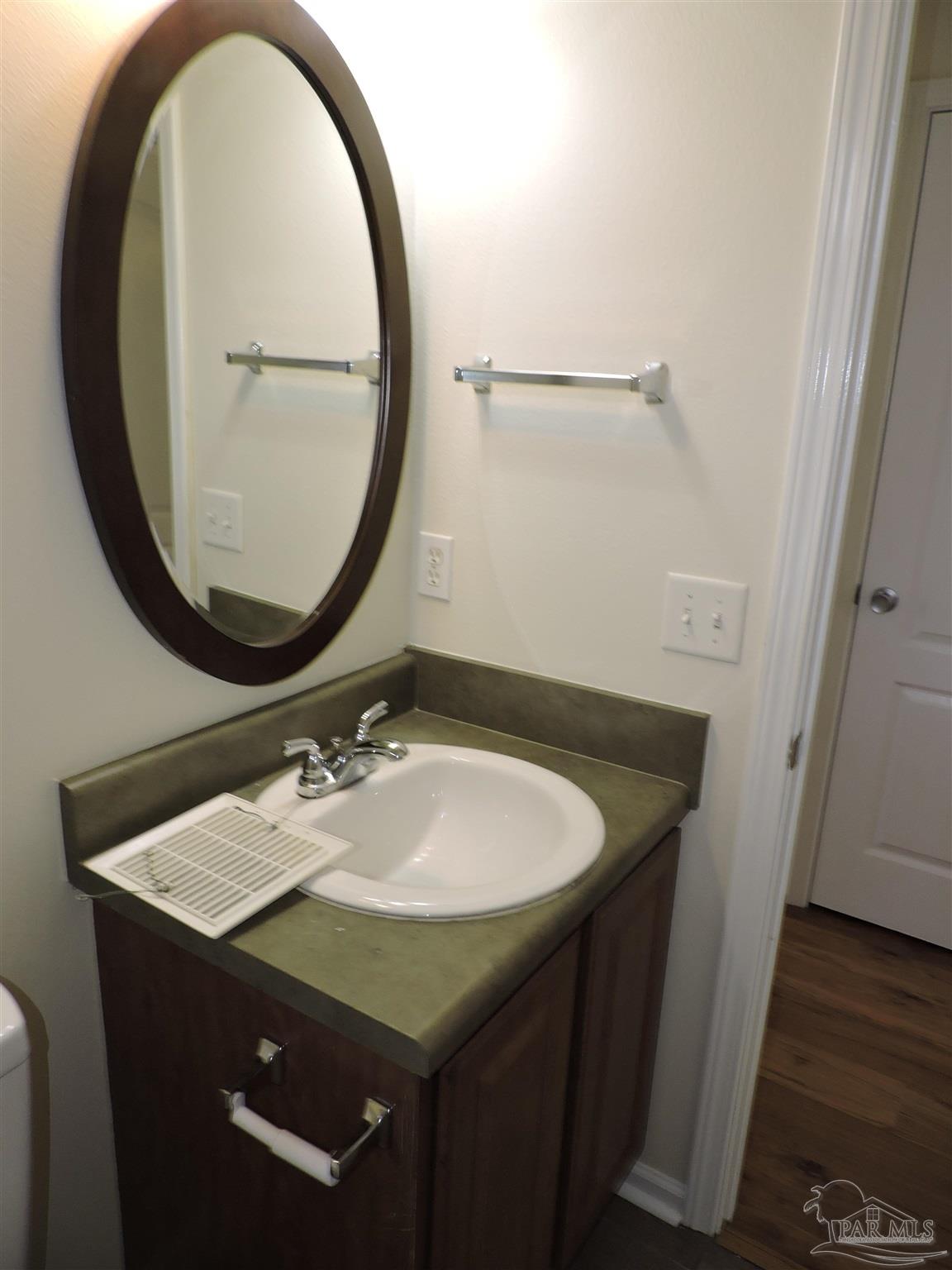7070 Marissa Point Lane Milton, FL 32570 - Photo 18 of 21 a bathroom with a sink and a mirror