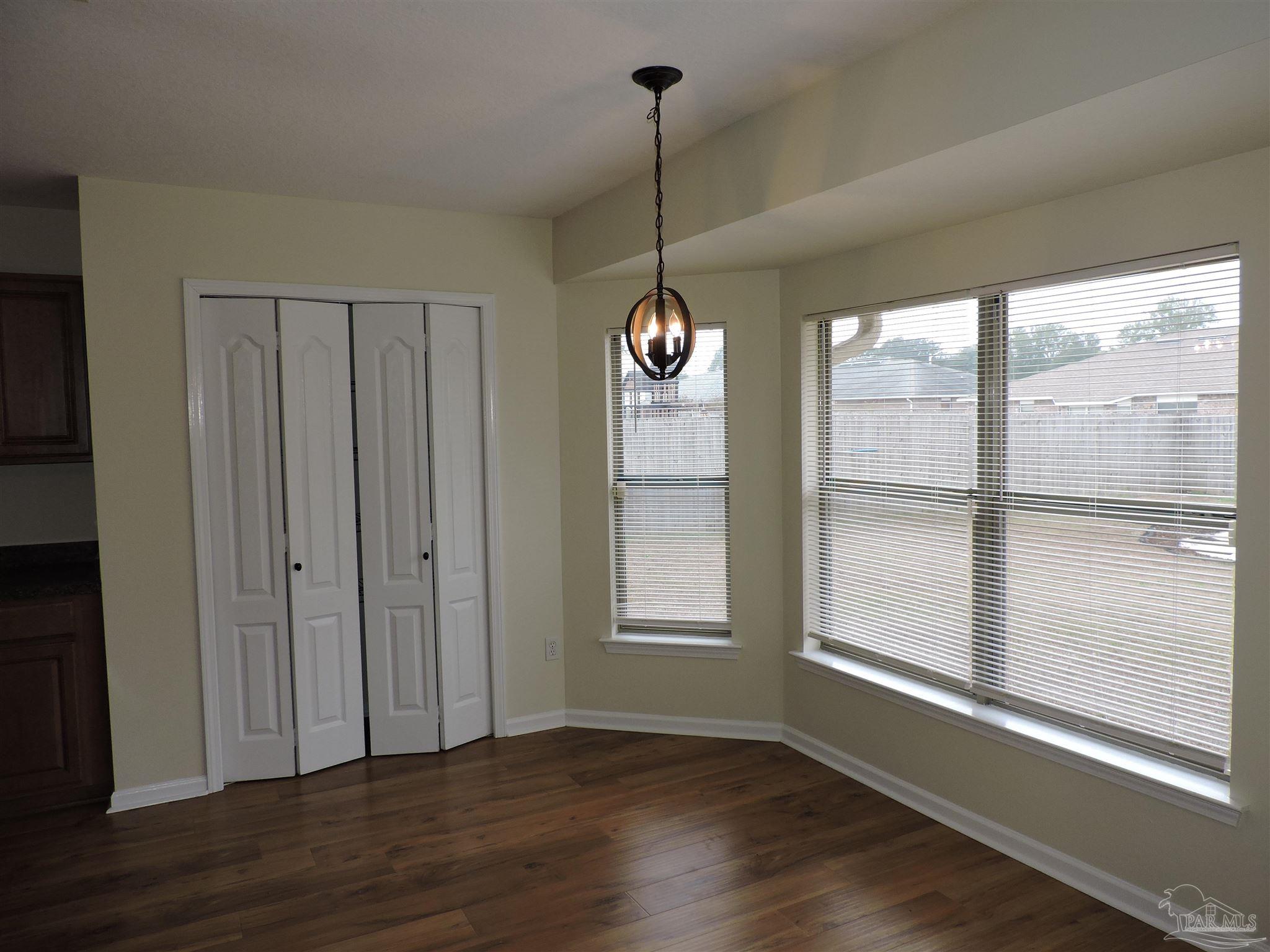 7070 Marissa Point Lane Milton, FL 32570 - Photo 5 of 21 a view of an empty room with wooden floor and a window