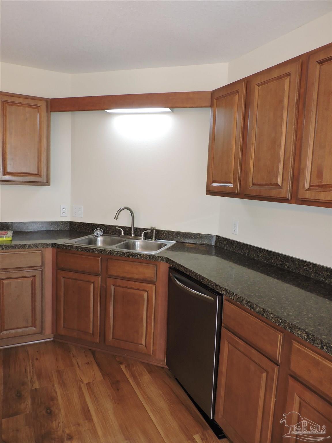 7070 Marissa Point Lane Milton, FL 32570 - Photo 8 of 21 a kitchen with granite countertop a sink and cabinets