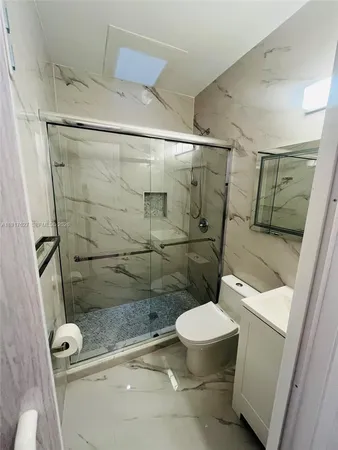 a bathroom with a toilet and a shower