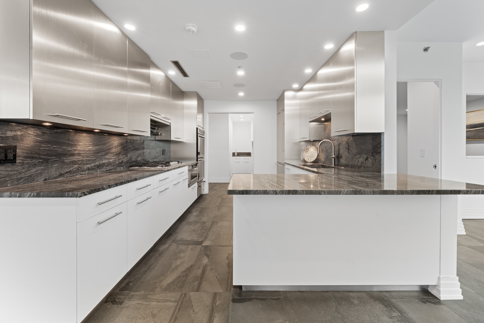 600 North Kingsbury Street, Unit 506 Chicago, IL 60654 - Photo 12 of 71 a large kitchen with kitchen island a large counter top stainless steel appliances and cabinets