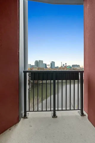 a kitchen with stainless steel appliances kitchen island granite countertop a stove and white cabinets
