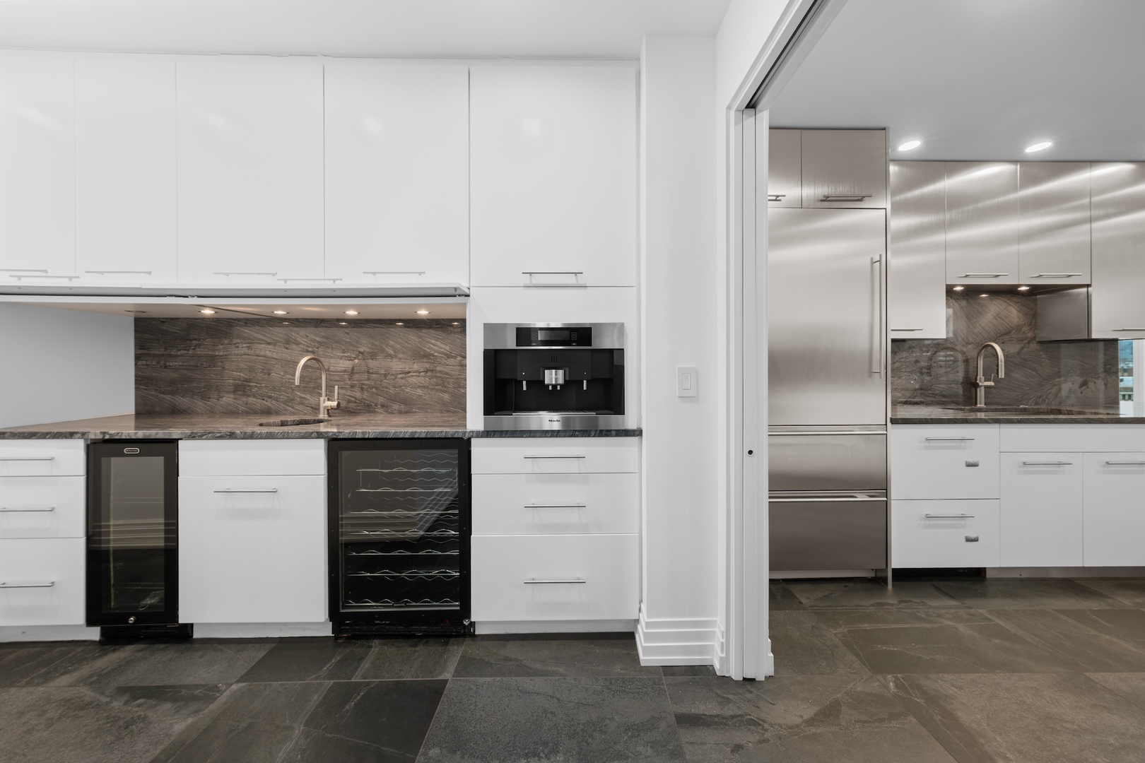 600 North Kingsbury Street, Unit 506 Chicago, IL 60654 - Photo 16 of 71 a kitchen with white cabinets and stainless steel appliances