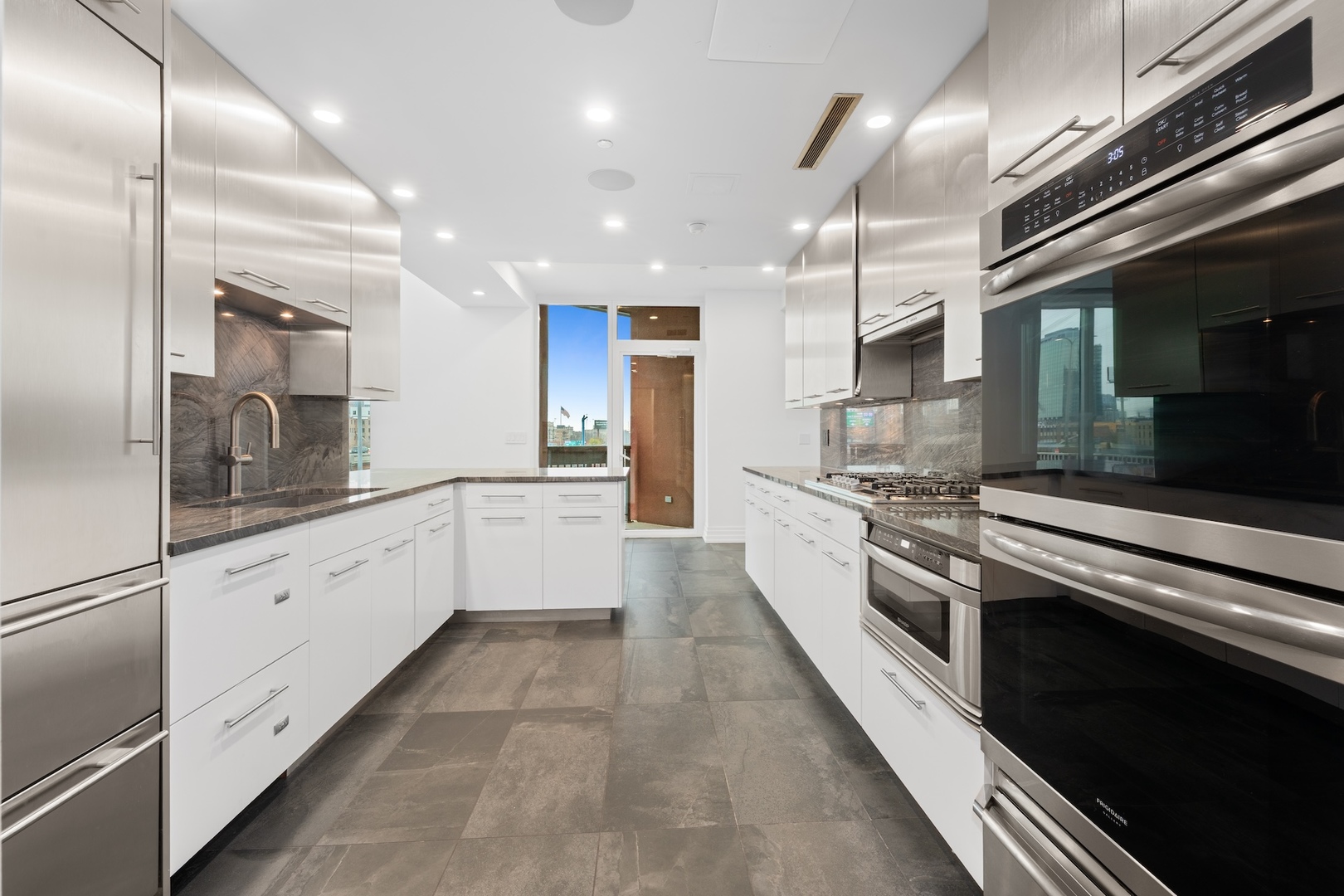 600 North Kingsbury Street, Unit 506 Chicago, IL 60654 - Photo 17 of 71 a large kitchen with stainless steel appliances kitchen island granite countertop a large counter top