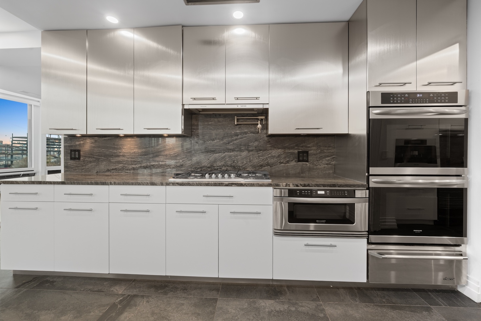 600 North Kingsbury Street, Unit 506 Chicago, IL 60654 - Photo 19 of 71 a kitchen with stainless steel appliances kitchen island granite countertop a stove a sink and a microwave