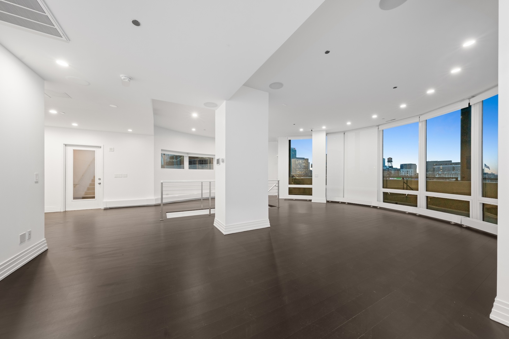 600 North Kingsbury Street, Unit 506 Chicago, IL 60654 - Photo 61 of 71 a view of an empty room with wooden floor and a kitchen
