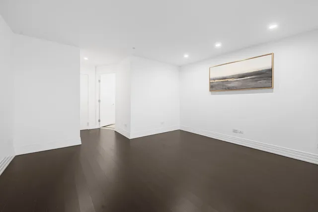 a view of a room with wooden floor and windows