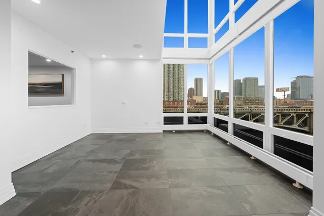 a large kitchen with kitchen island a large counter top stainless steel appliances and cabinets