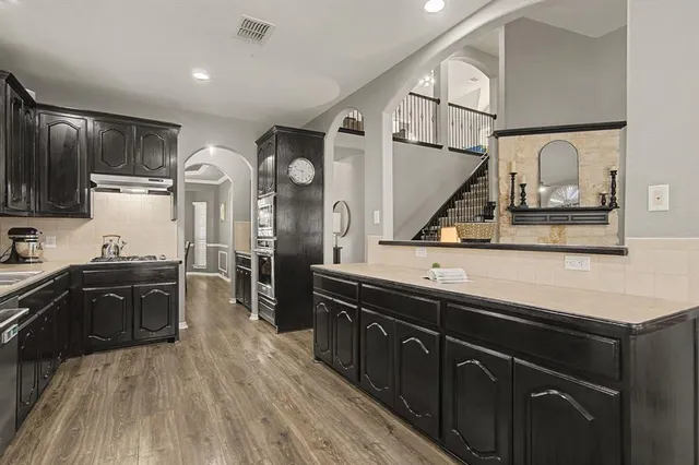 a bedroom with a bed and a dresser with mirror