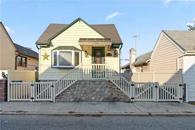a view of a house with wooden fence