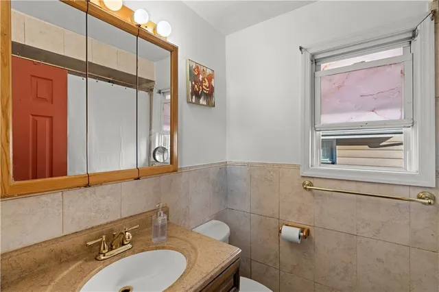 a bathroom with a sink a mirror and a shower