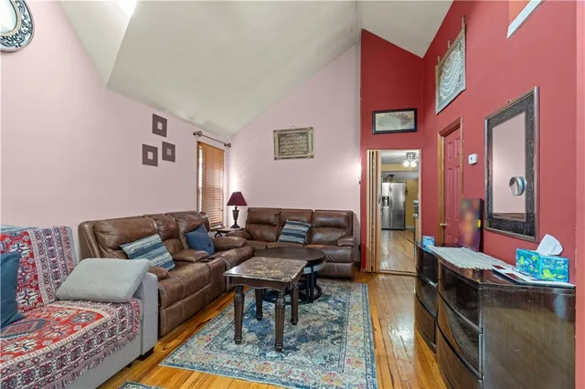 a living room with furniture wooden floor and a table