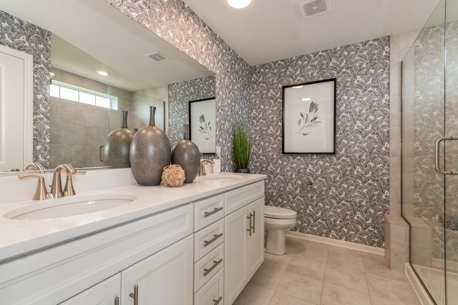 1233 Draper Road McHenry, IL 60050 - Photo 14 of 14 a bathroom with a double vanity sink toilet and shower