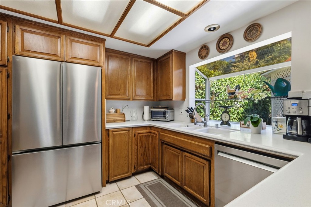 18233 Charlton Lane Porter Ranch, CA 91326 - Photo 36 of 40 a kitchen with stainless steel appliances granite countertop a refrigerator a sink and a stove