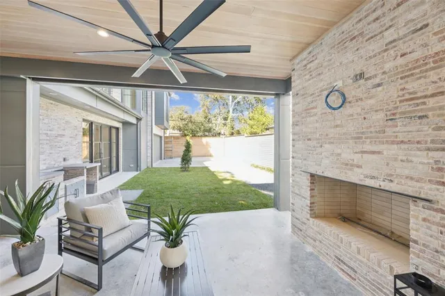 a living room with patio furniture and a floor to ceiling window