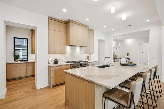a kitchen with a stove a sink and a refrigerator