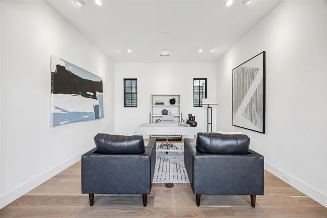 a living room with furniture and a wall painting