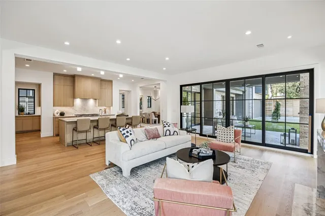 a living room with furniture and large windows