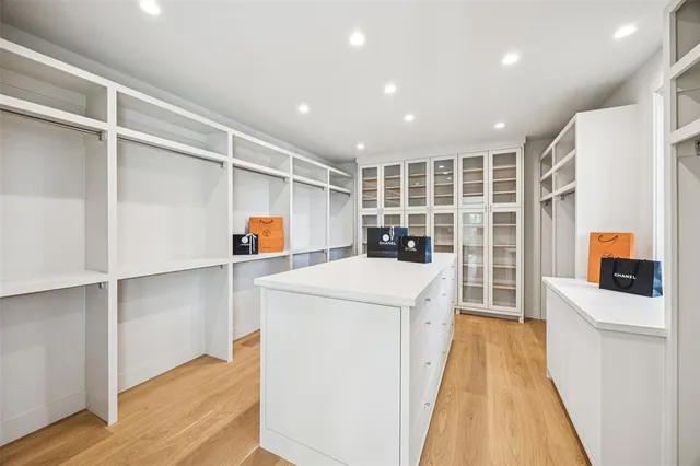 a kitchen with a refrigerator and a stove top oven