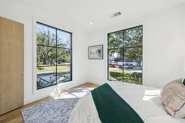 a bed sitting in a bedroom next to a window
