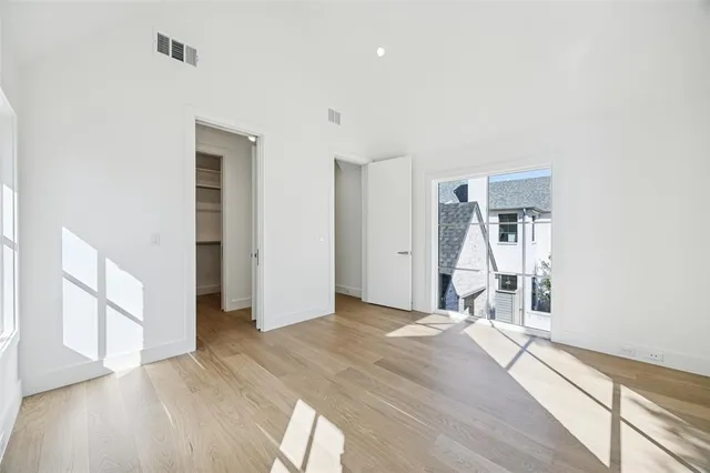 a view of a room with wooden floor and a window