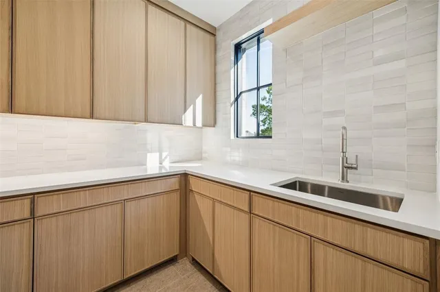 a kitchen with a sink and cabinets