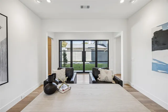 a bedroom with furniture and large windows