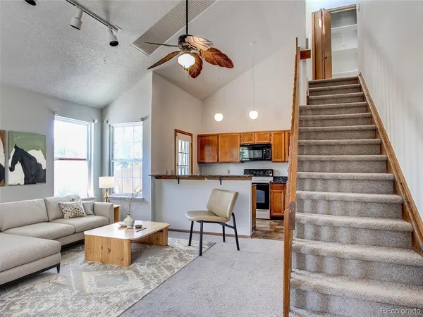 a living room with furniture and kitchen view