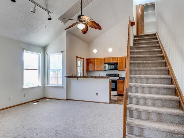 a kitchen with stainless steel appliances granite countertop a refrigerator and a stove top oven