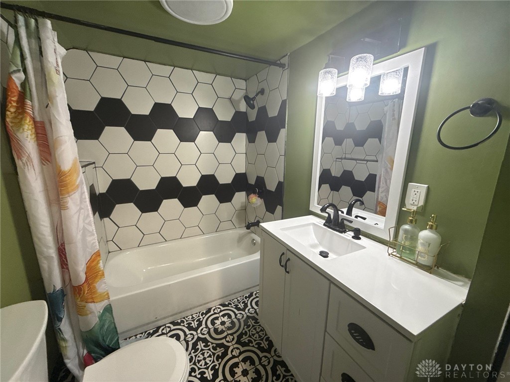 1125 West High Street Springfield, OH 45506 - Photo 17 of 39 This bright bathroom features bold tile work and a clean vanity, creating a refreshing atmosphere.