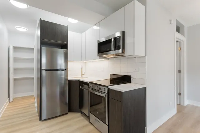 a kitchen with a refrigerator stove and microwave
