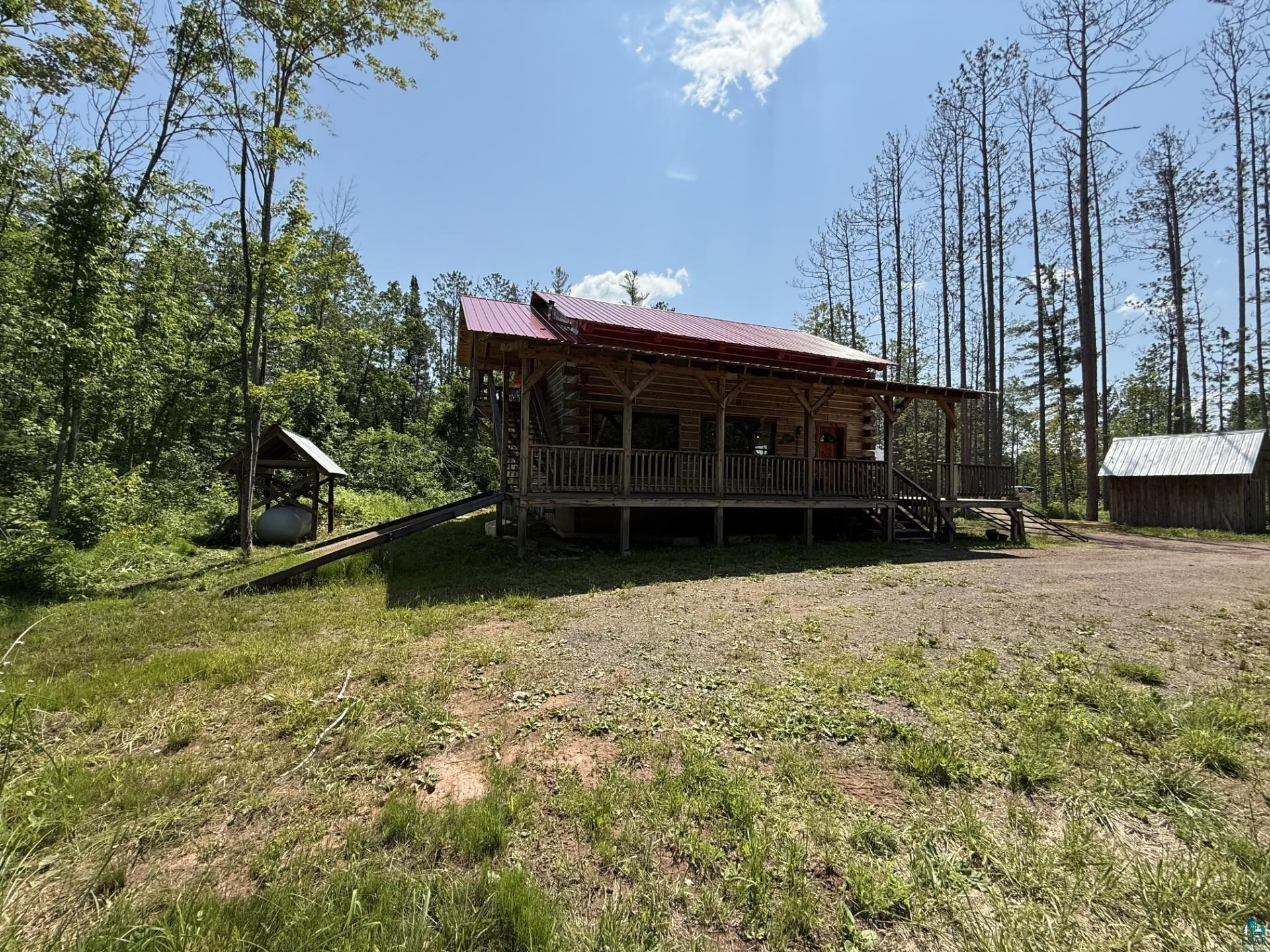 66795 Janecek Road Ashland, WI 54806 - Photo 5 of 10 Back of property with a metal roof, log exterior, and a porch