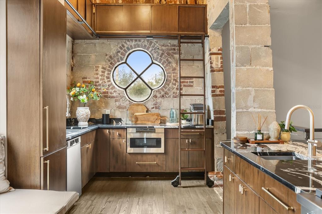 601 East Ridgewood Street Orlando, FL 32803 - Photo 13 of 86 a kitchen with stainless steel appliances granite countertop a stove and a sink