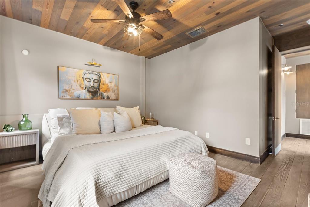 601 East Ridgewood Street Orlando, FL 32803 - Photo 25 of 86 a bedroom with a large bed and a chandelier