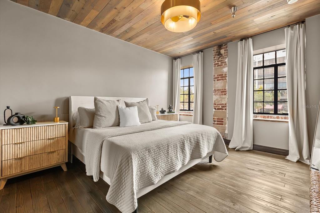 601 East Ridgewood Street Orlando, FL 32803 - Photo 31 of 86 a bedroom with a bed and wooden floor