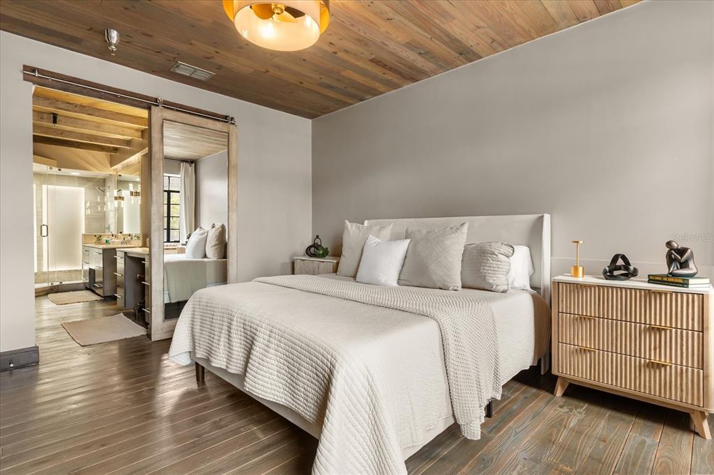 601 East Ridgewood Street Orlando, FL 32803 - Photo 33 of 86 a bedroom with a bed and wooden floor