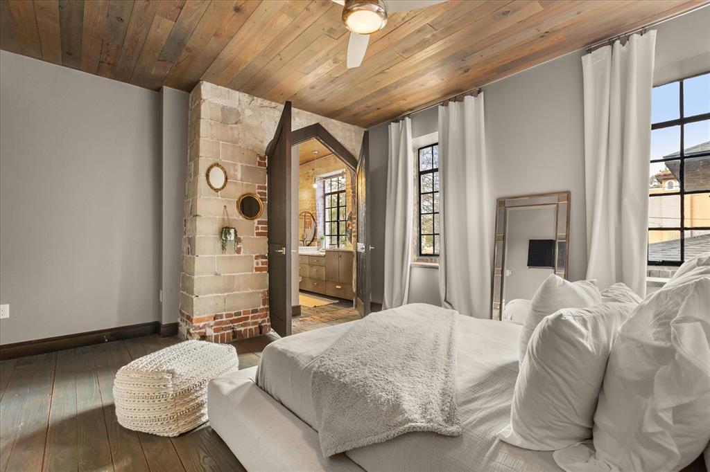 601 East Ridgewood Street Orlando, FL 32803 - Photo 41 of 86 a spacious bedroom with a bed and a chandelier