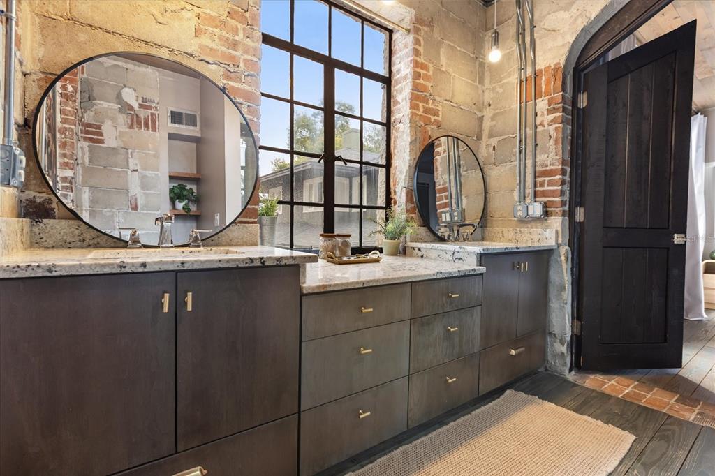 601 East Ridgewood Street Orlando, FL 32803 - Photo 43 of 86 a bathroom with a granite countertop sink a mirror and a shower