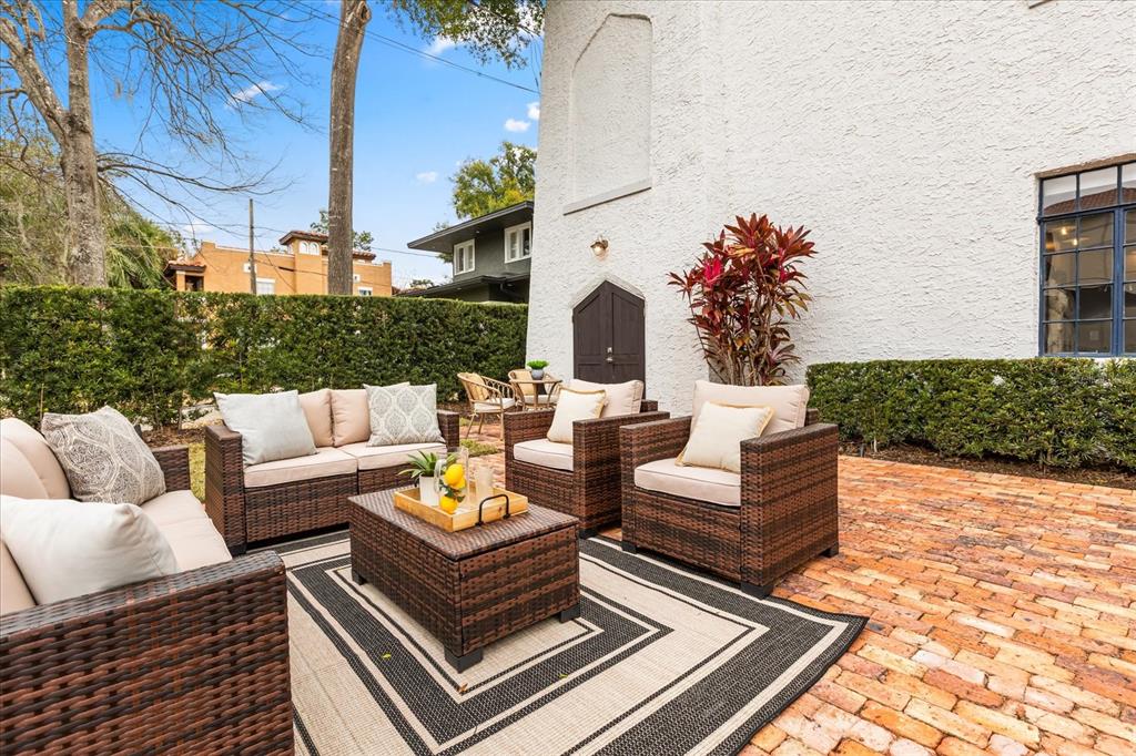 601 East Ridgewood Street Orlando, FL 32803 - Photo 67 of 86 a outdoor living room with furniture and a potted plant