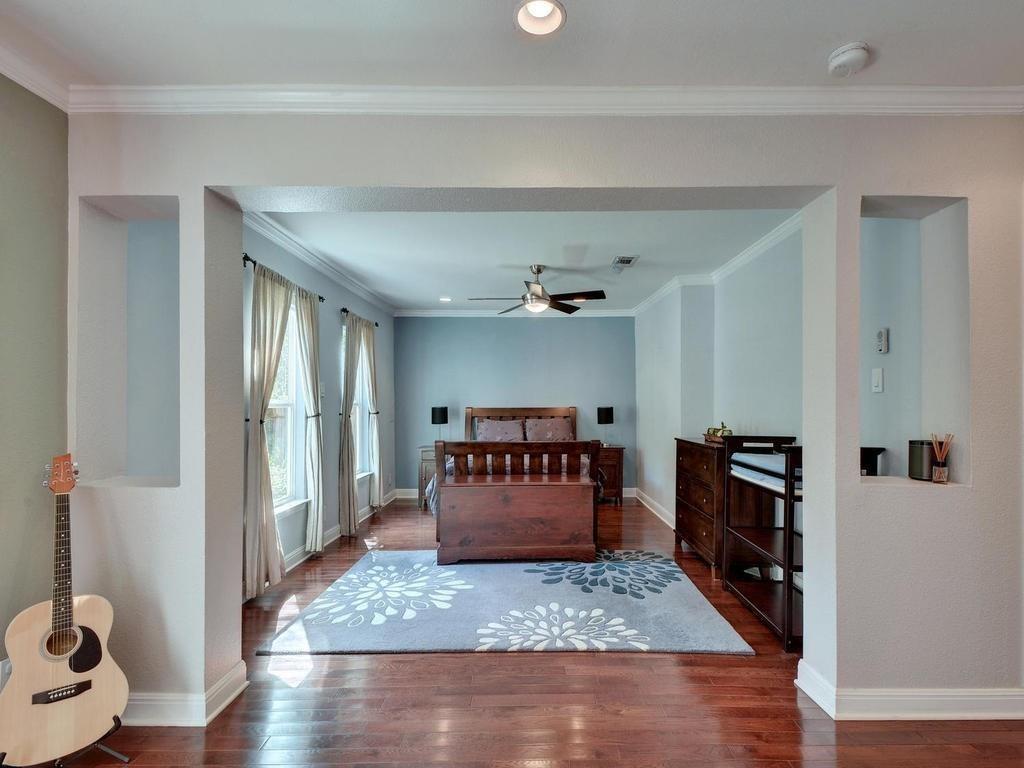 610 West N Loop Boulevard Austin, TX 78751 - Photo 6 of 29 The property features dark hardwood floors and crown molding
