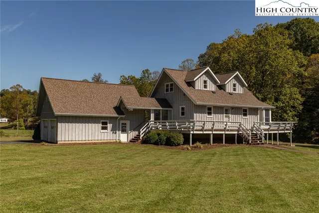 a front view of a house with a garden and deck
