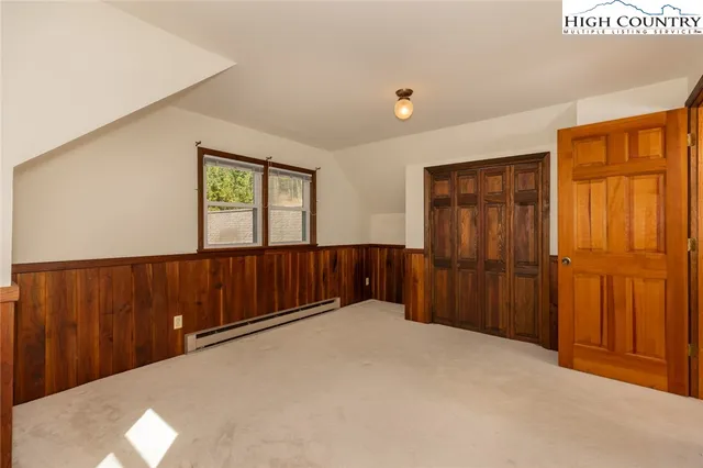 a bathroom with a granite countertop sink toilet and mirror
