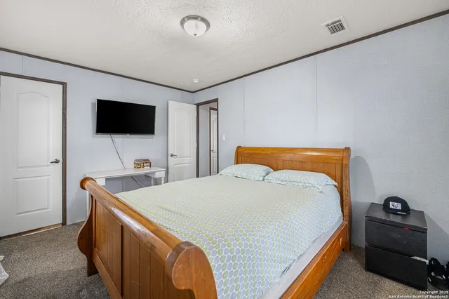 a bedroom with a bed and a dresser