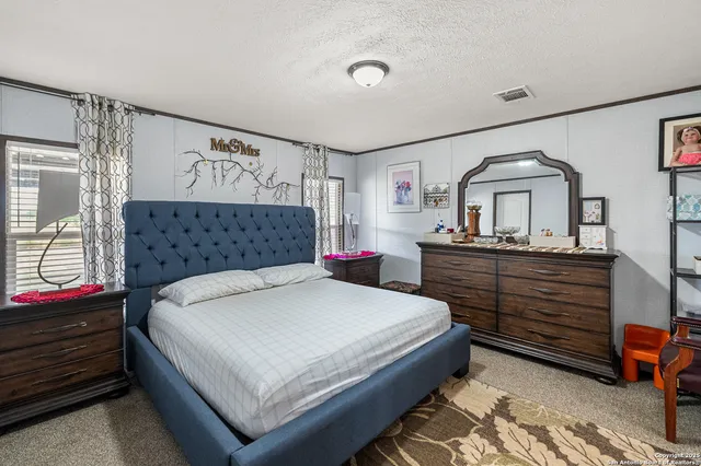 a spacious bathroom with a granite countertop sink toilet and mirror