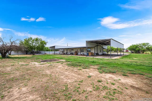 a view of a backyard with wooden fence