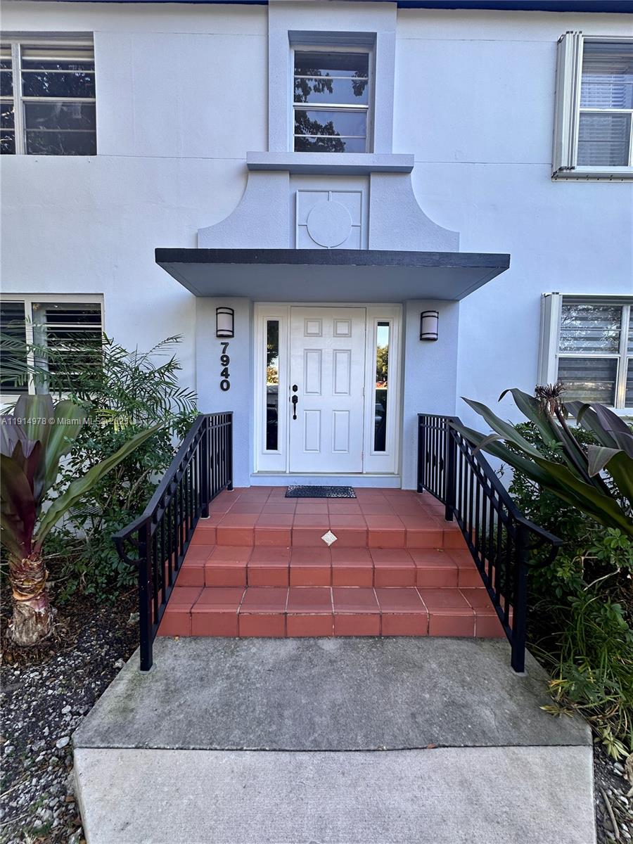 7940 Southwest 55th Avenue, Unit 67D Miami, FL 33143 - Photo 1 of 16 a front view of a house with a yard