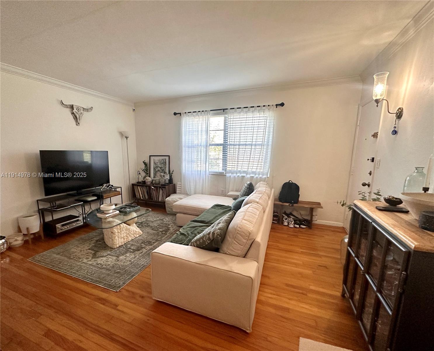 7940 Southwest 55th Avenue, Unit 67D Miami, FL 33143 - Photo 4 of 16 a living room with furniture and a flat screen tv